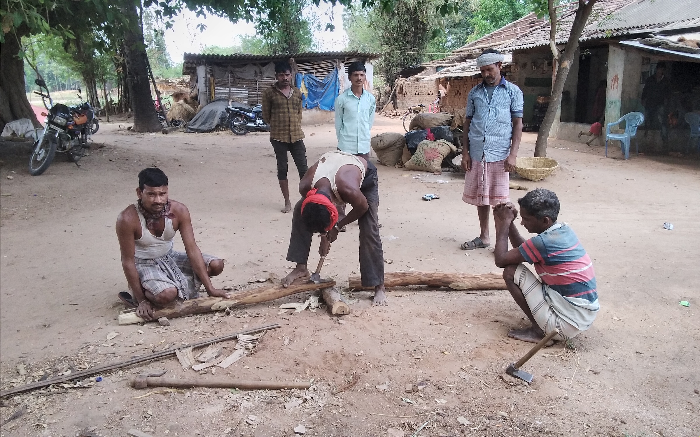 Rathwa men chopping wood to make ploughs for the upcoming sowing season, Moti Sadli, Gujarat.