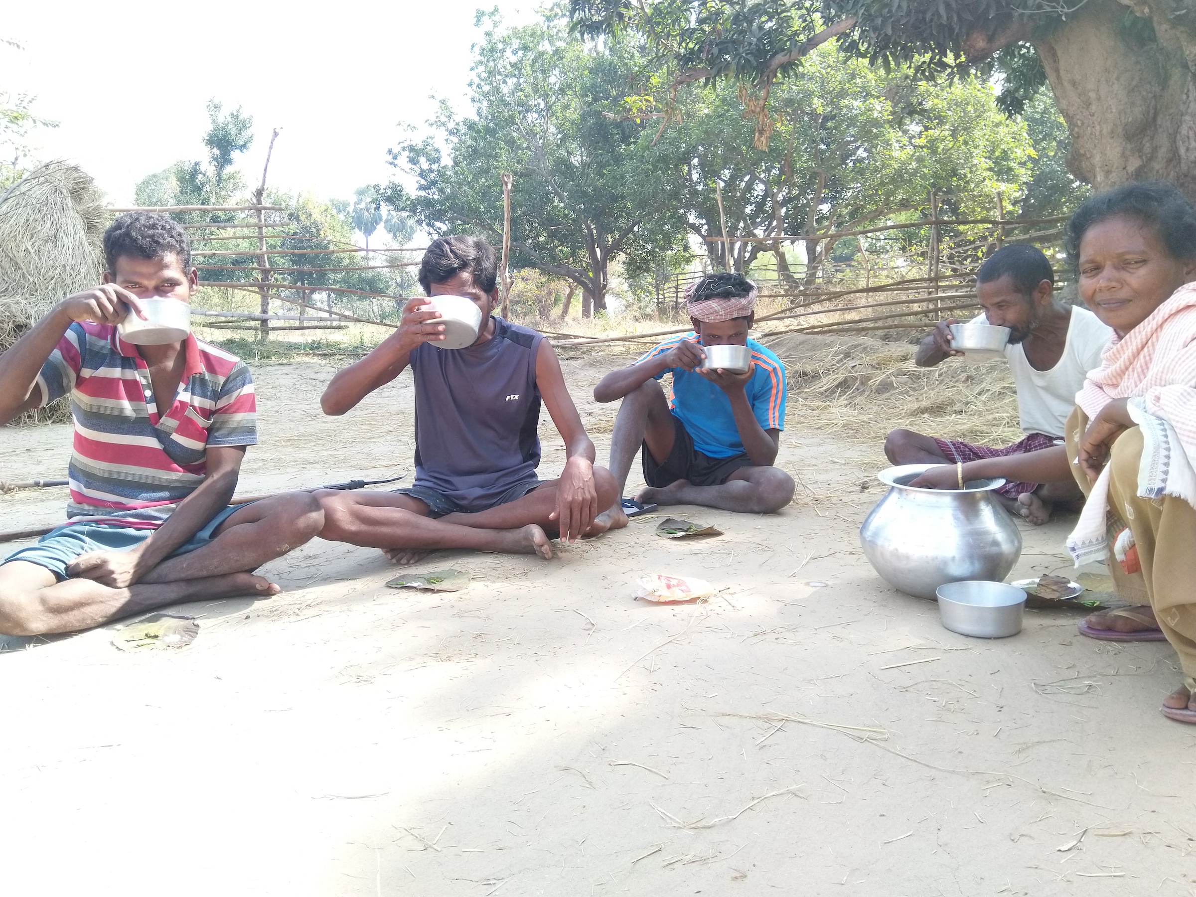 Woman distributing rice beer, Bharbharia, Jharkhand.